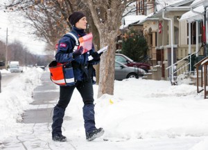 OTTAWA, ONTARIO: DECEMBER 11, 2013 -- Letter carrier Christina Staniszewski, who has been delivering mail for the last six years, found out Wednesday morning by text while delivering mail along Ross St in Ottawa's west end, that Canada Post plans to phase out urban mail delivery within 5 years. (Wayne Cuddington / Ottawa Citizen) 115469